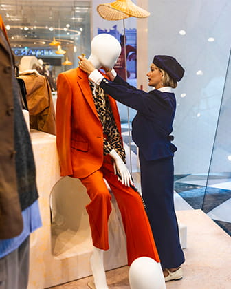 employee adjusting a mannequin