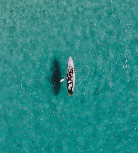 Top view of paddle boat in clear water