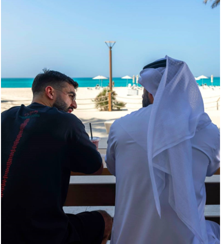 two men having a conversation at yas island