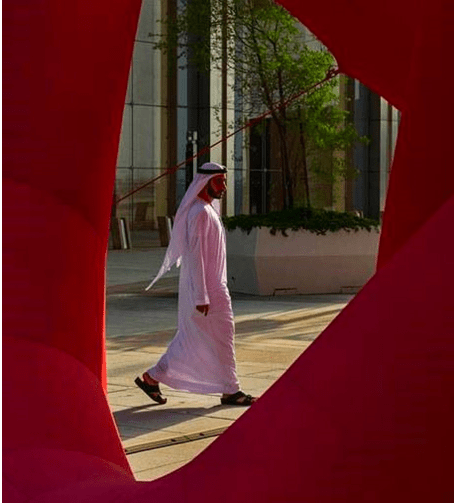 Man wearing an abaya with a red background