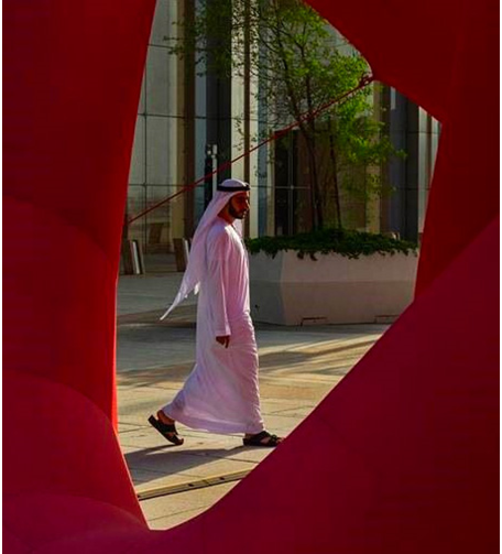 Man wearing an abaya with a red background