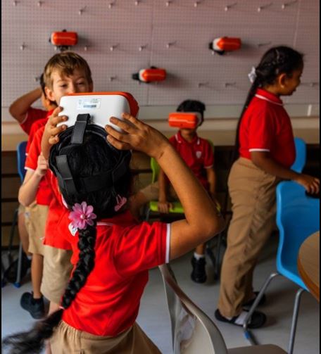 Kids using VR glasses in a classroom